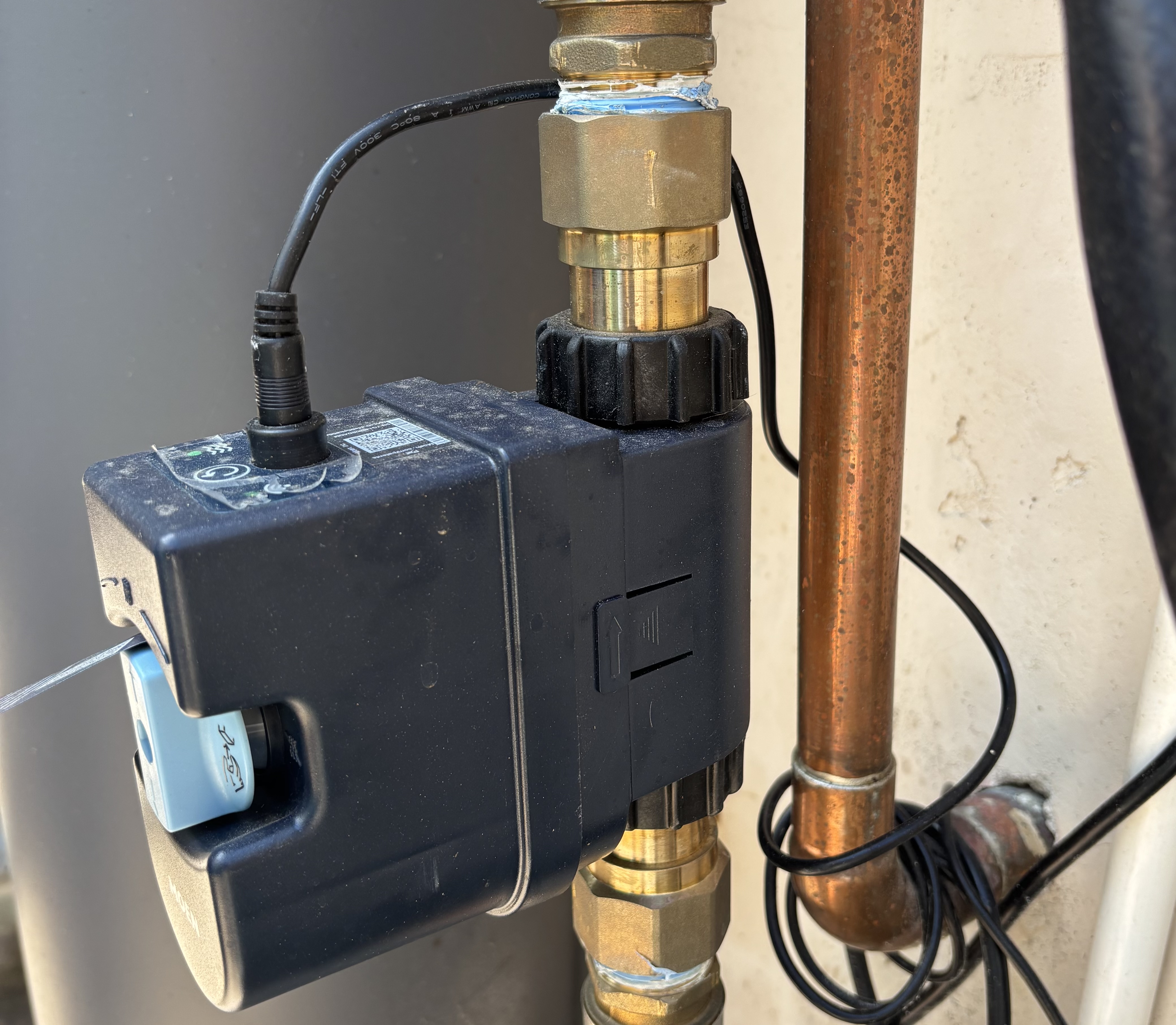 Close up of brass unions and copper fittings on a Moen Flo smart shutoff valve installation in Chula Vista