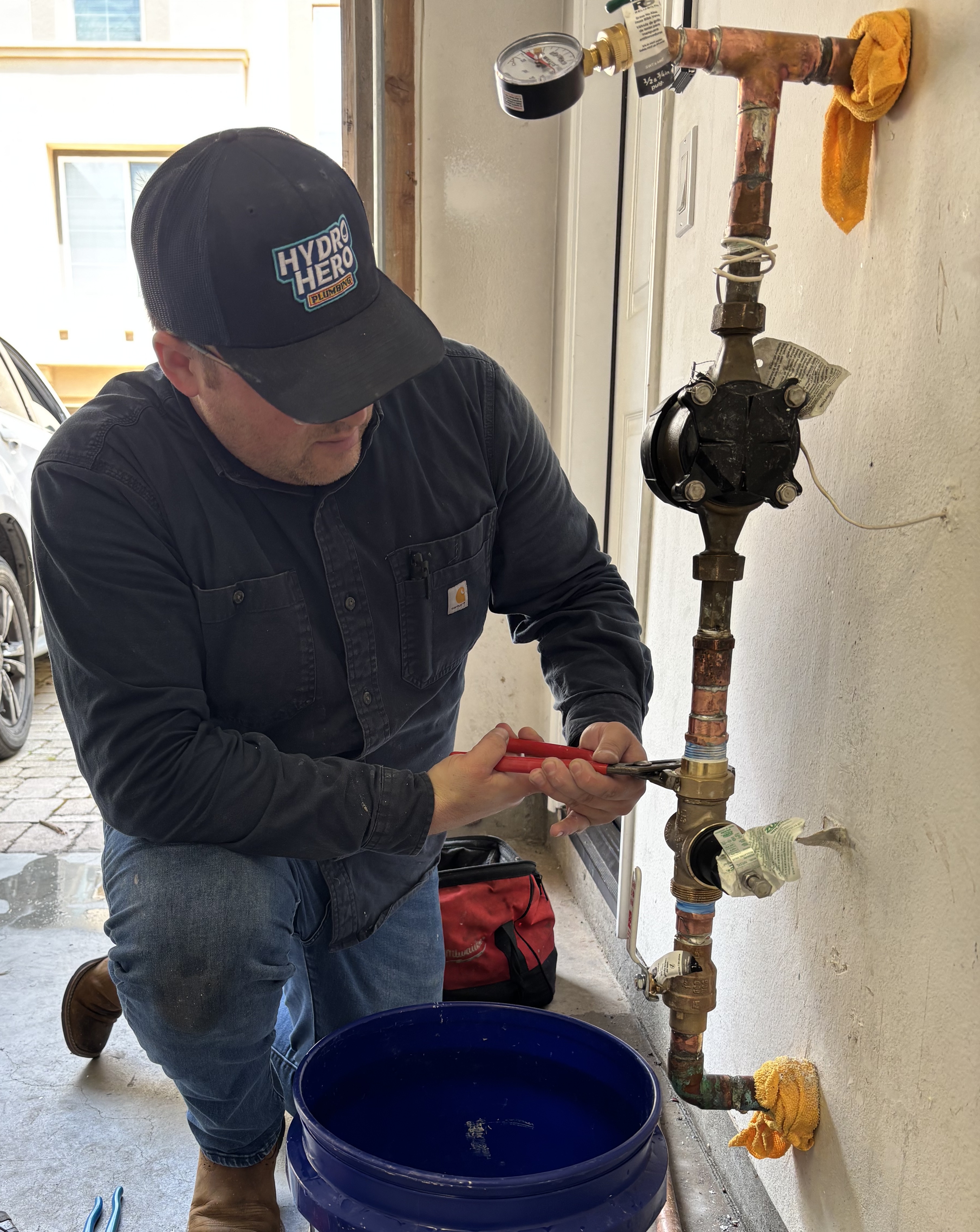 Hydro Hero Plumbing technician installing a Moen Flo smart water shutoff valve on the main line in Eastlake, Chula Vista