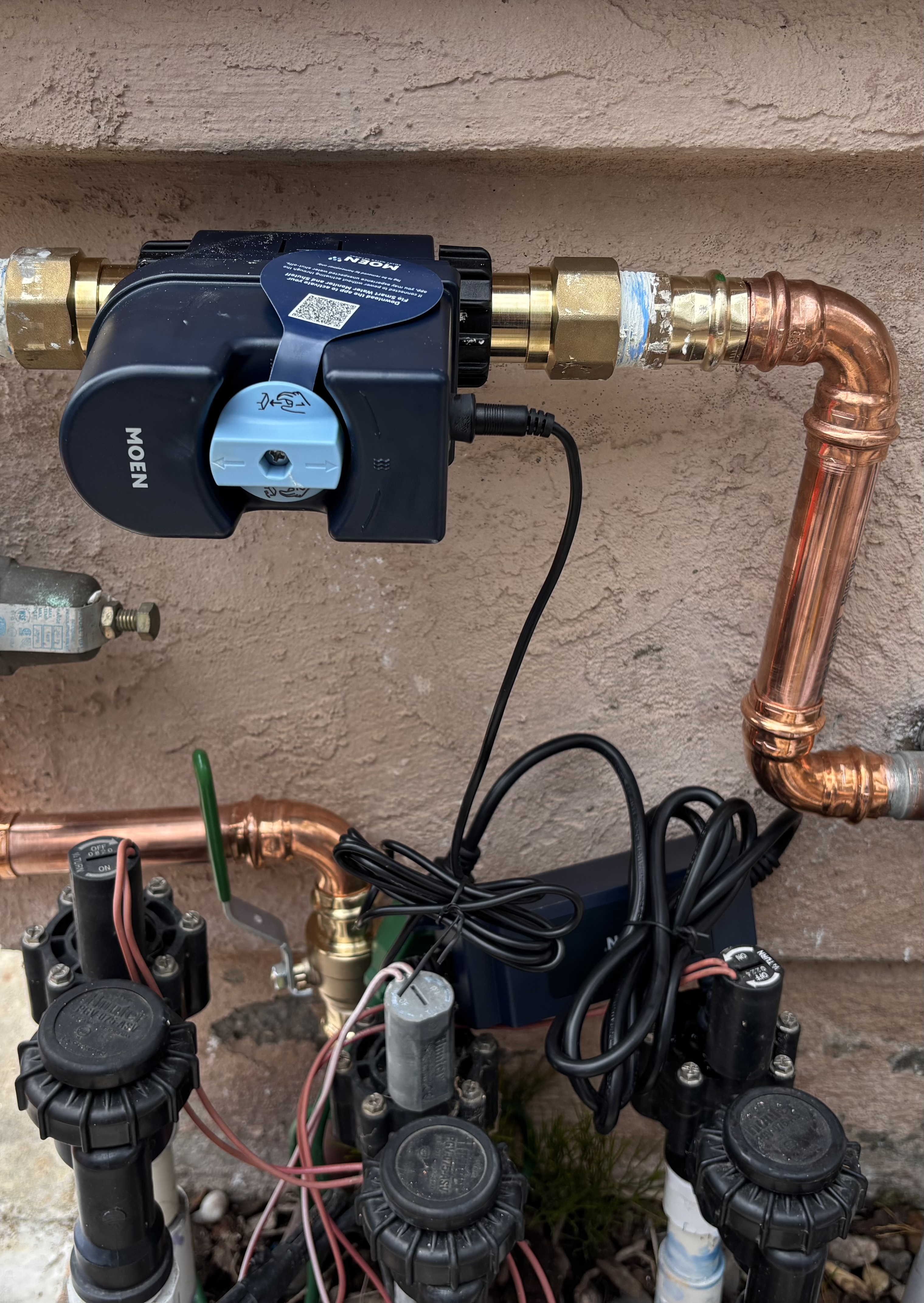 Moen Flo smart water shutoff valve installed outdoors beside an irrigation valve manifold in Eastlake, Chula Vista
